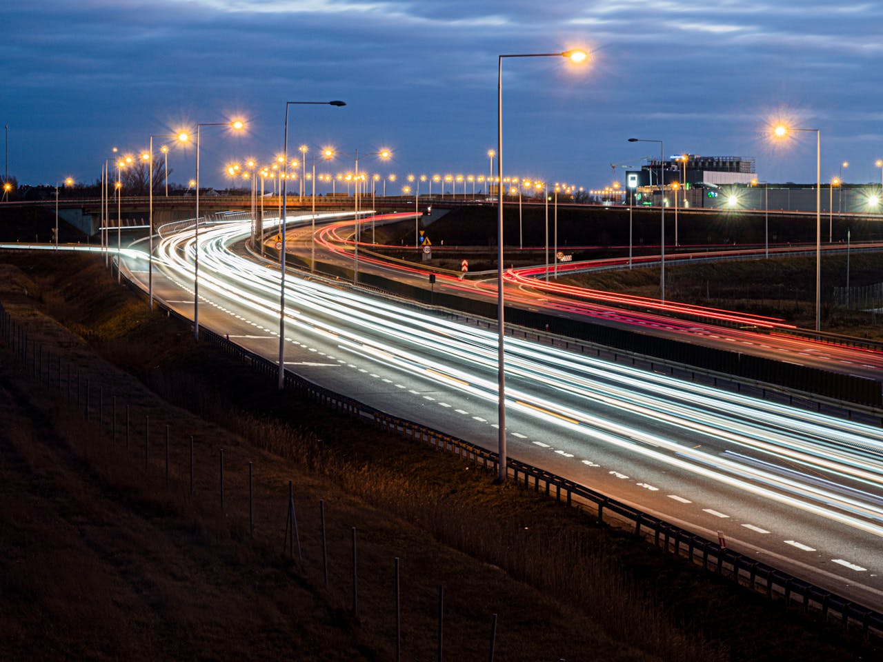 Long exposure of headlights and taillights on a freeway in Wrocław at night.